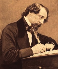 Charles Dickens writing with a feather quill