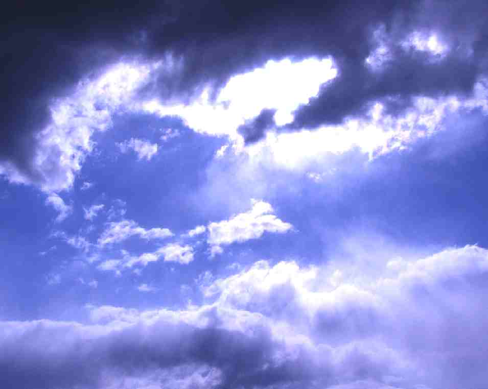 Sunlight blue skies bursting through storm clouds