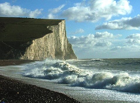 The Seven Sisters background to a wonderful rolling wave on a cloudy day