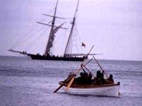La Amistad schooner at sea and rowing boat