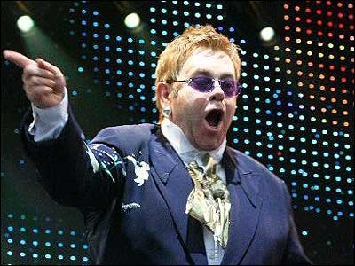Elton John blue jacket sunglasses