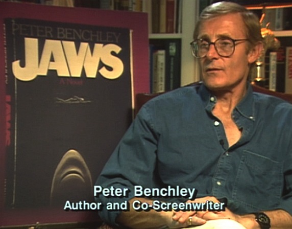 Peter Benchley sitting beside Jaws book cover art