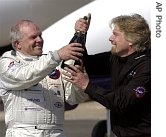 Steve Fossett, left, and Sir Richard Branson celebrate after Fossett landed the GlobalFlyer at the Salina Municipal Airport in Salina, Kansas