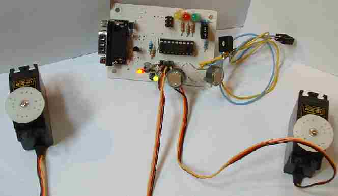 Test rig of comparator photoresistor circuit powering two servos