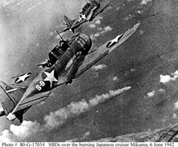 Dive bombers over the burning Japanese cruiser Mikuma during the Battle of Midway