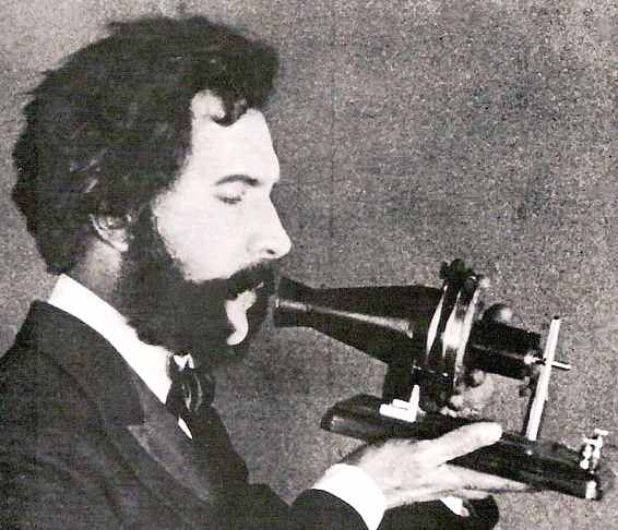Alexander Graham Bell speaking into his telephone invention