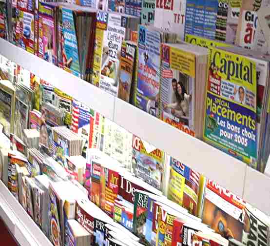 A magazine news rack , typical newsagent layout